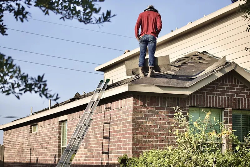 Professional roofer working on a residential roof in West Bloomfield